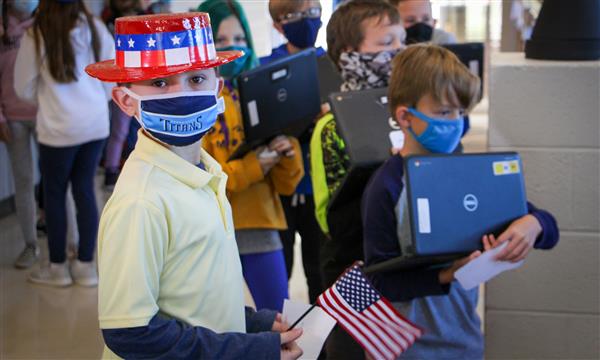 Student dressed as a voting volunteer looks at camera